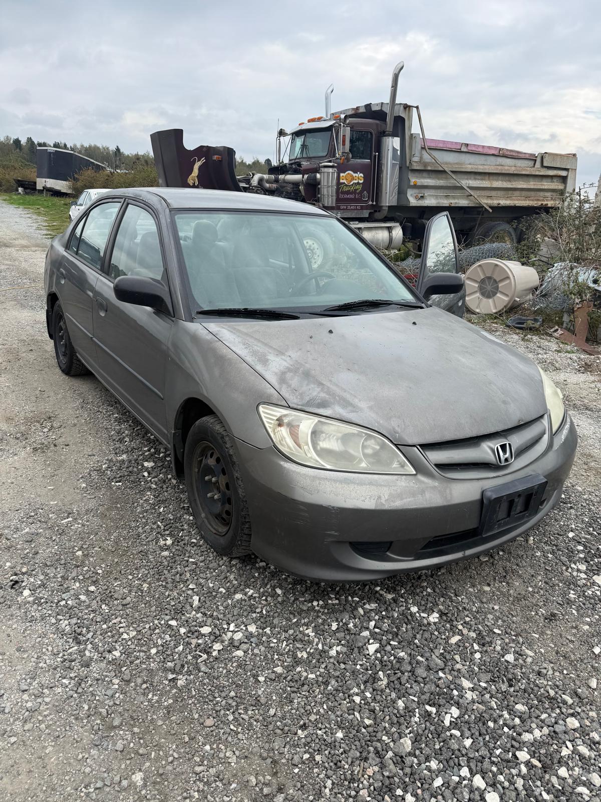 Tow truck hauling junk car for scrap car removal service